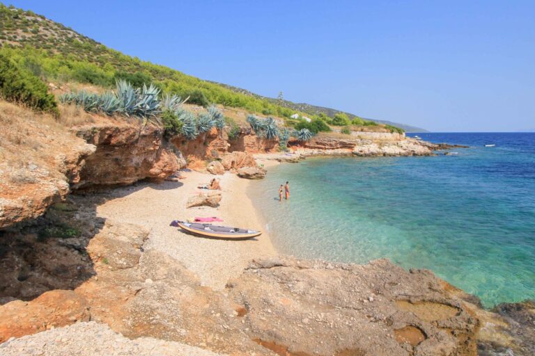 beach with rocky cliffs and clear blue water, Hvar (Dalmatia)