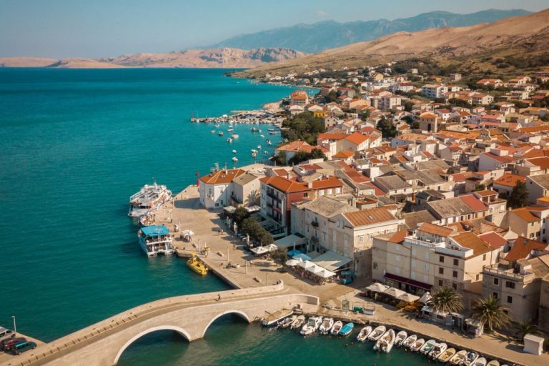 coastal town with colorful houses and boats in the harbor, Pag