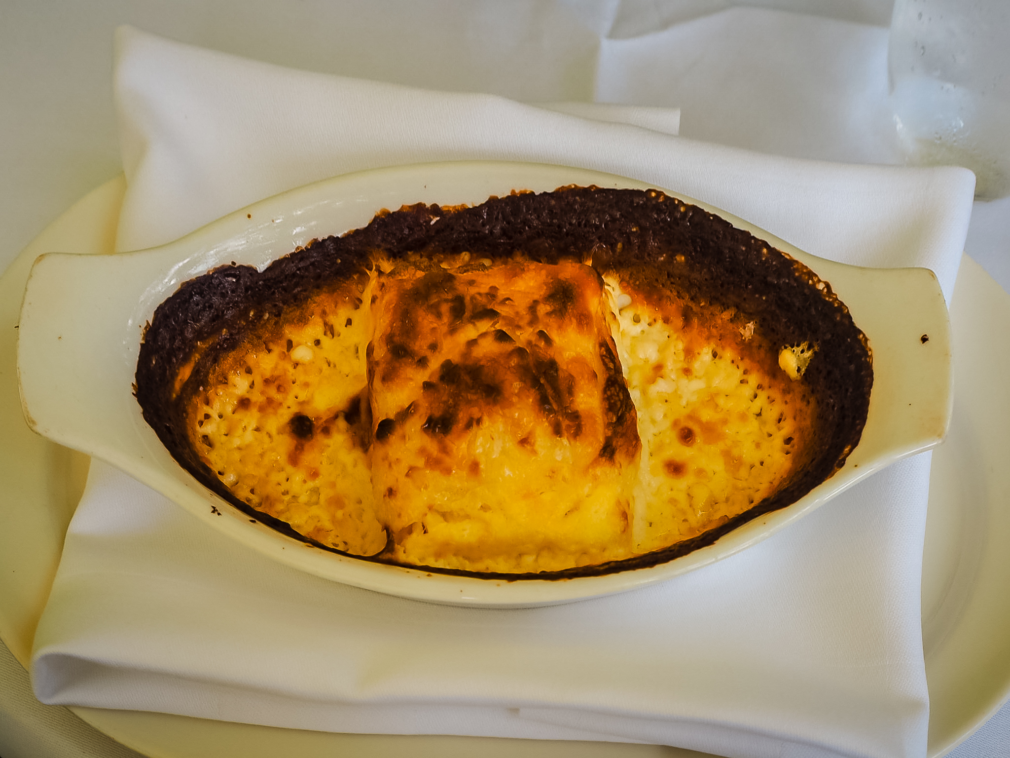 Štrukli: baked Croatian cheese pastry in a white dish